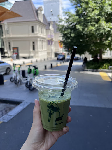 Kompass Coffee drink held outside near Albert Park